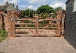 Rear view of hardwood gates treated in mid brown wood preserver